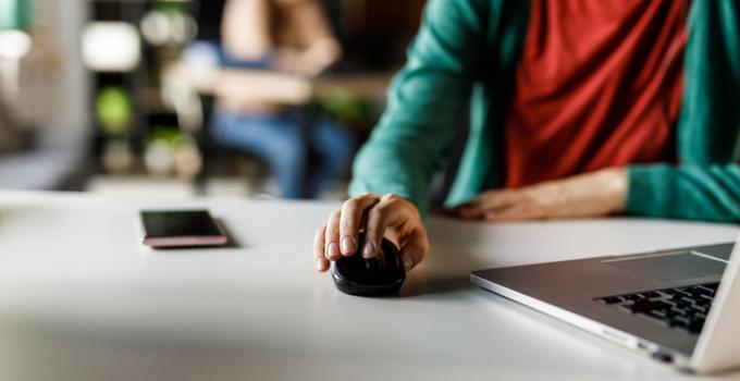 person with hand on computer mouse